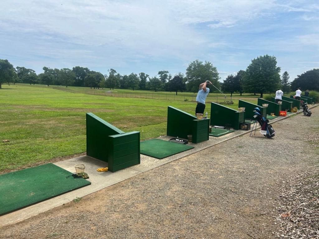 Golfers playing on the driving range