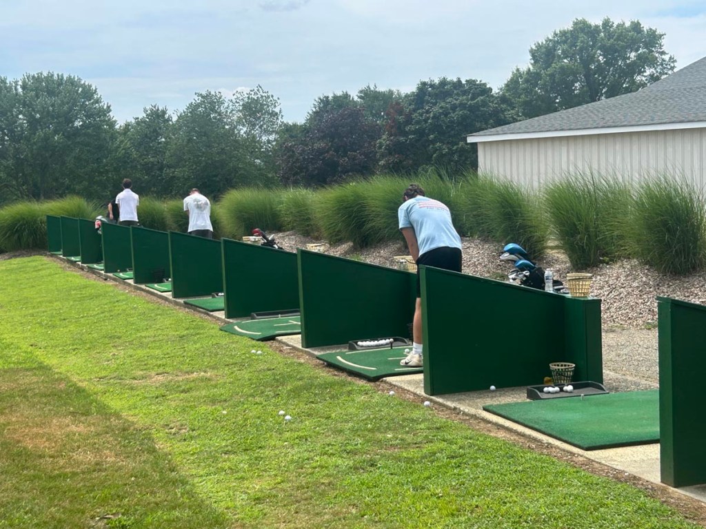 Golfers playing on the driving range
