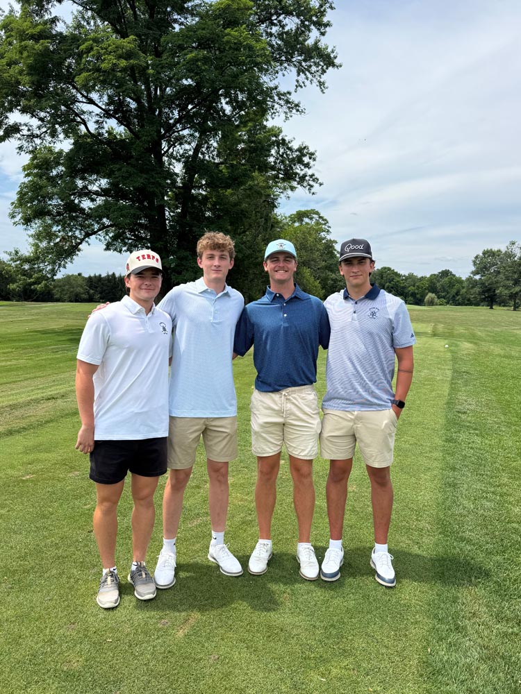4 men smile for the camera